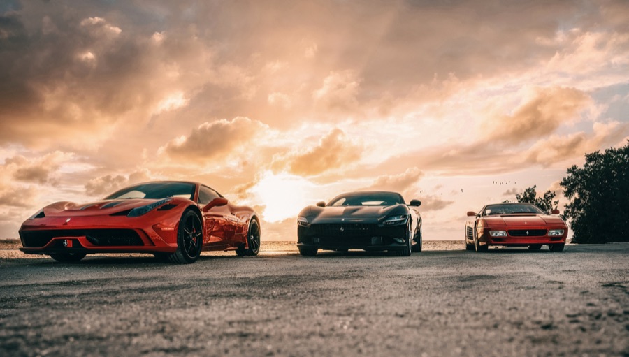 Three sports cars at sunset
