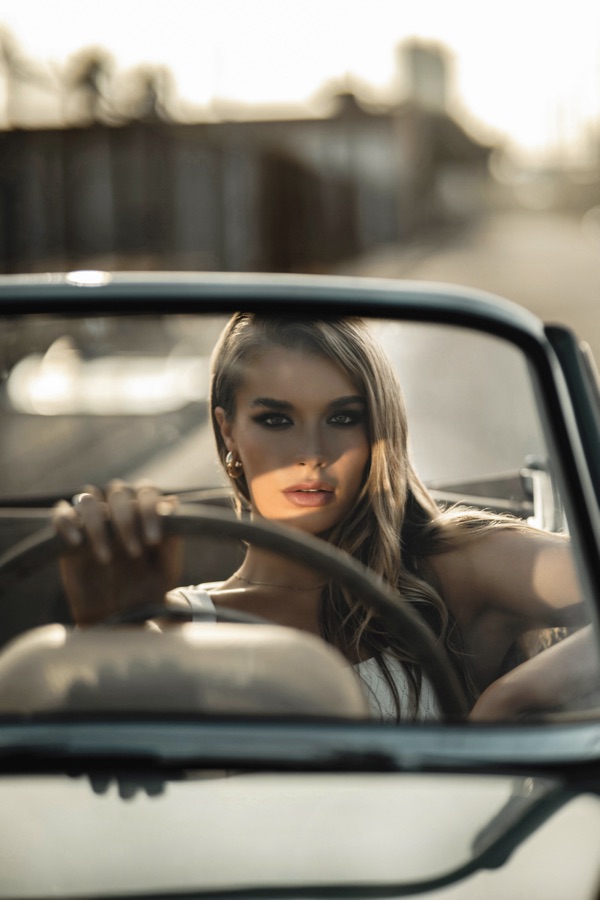 Portrait at the wheel of a classic convertible