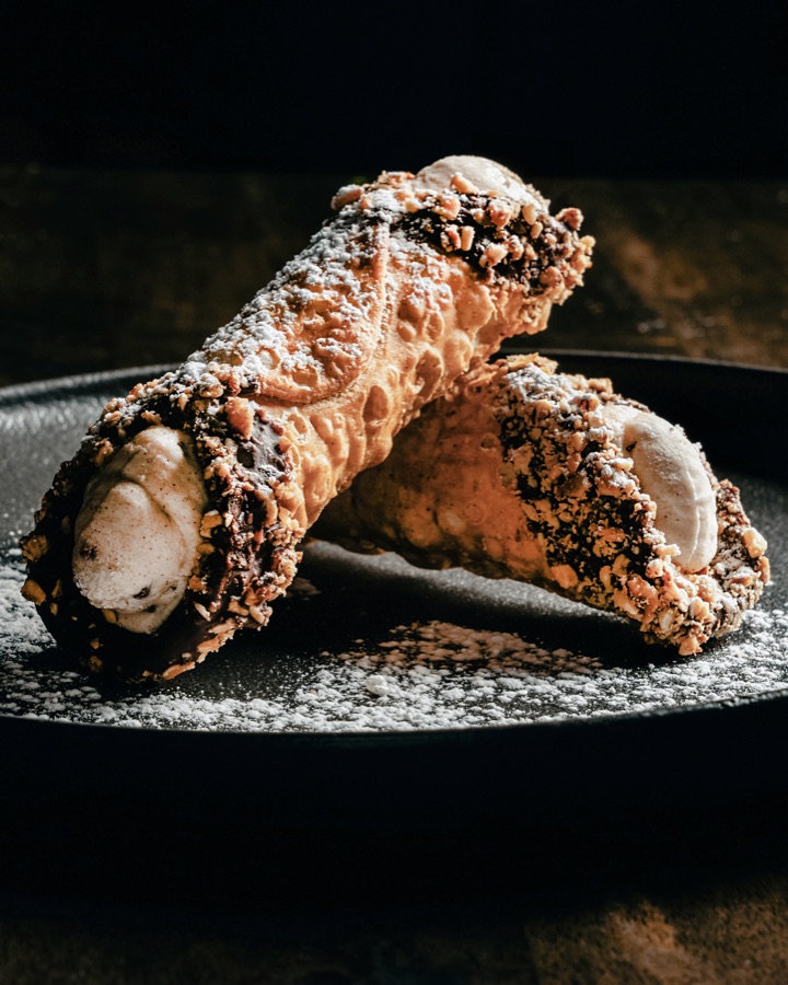 Cannoli on a dark plate